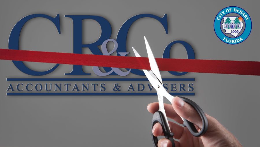 CR&Co Logo behind a ribbon being cut with scissors